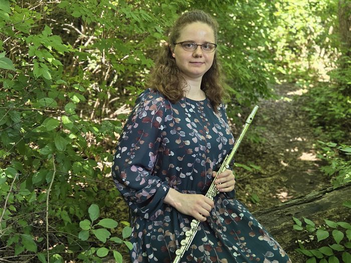 Veda Bergwall holding her flute outdoors